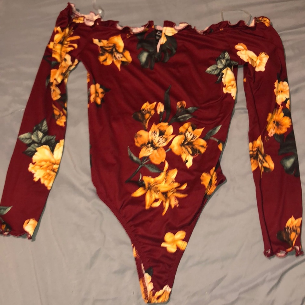 Burgundy body shirt with yellow followers and a v cut in the middle